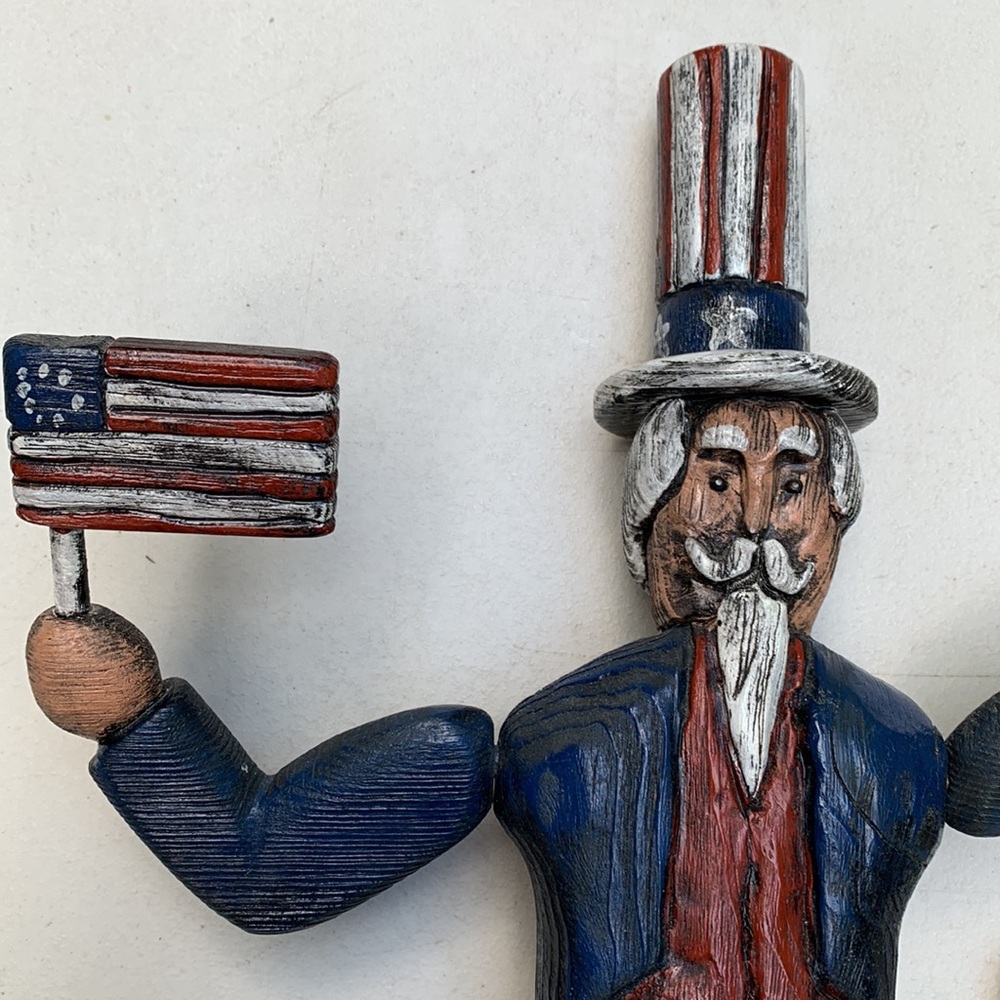 Hand carved wooden figure Uncle Sam holding flags by D. Gregan